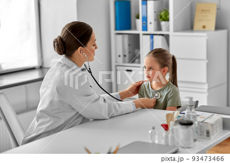 doctor with stethoscope and girl patient at clinic 93473466