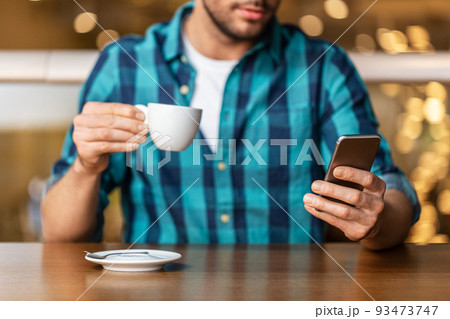 man with coffee and smartphone at restaurant man with coffee and smartphone at restaurant 93473747