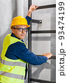 architect in helmet and goggles climbing stairs 93474199