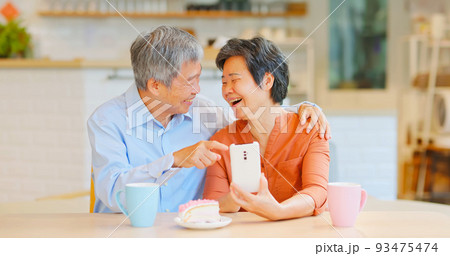 old couple use phone 93475474