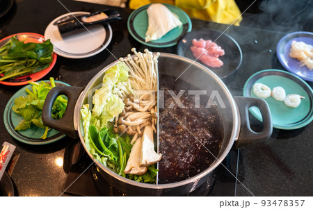 Set of vegetables and meat preparing for eat with hotpot. Hotpot is an interactive meal in which diners sit around a simmering pot of soup at the center of the table with ingredients. 93478357