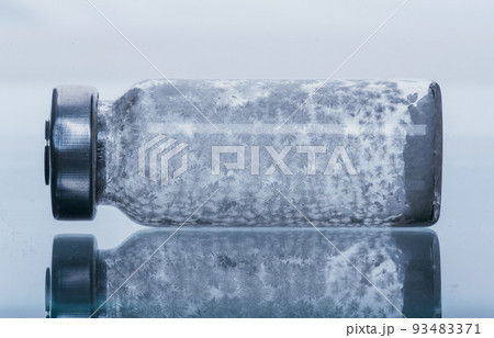 Glass medical ampoule vial for injection. Medicine is dry white drug penicillin powder or liquid with of aqueous solution in ampulla. Close up. Glass medical ampoule vial for injection. Medicine is dry white drug penicillin powder or liquid with of aqueous solution in ampulla. Close up. 93483371