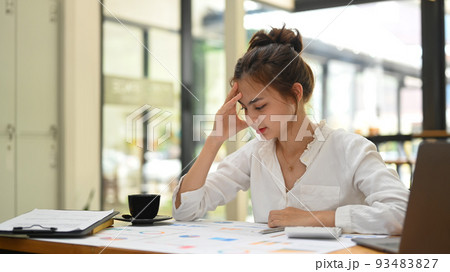 Confused young female office worker sitting at office desk thinking of problem solution. Emotional pressure, stress at work concept 93483827