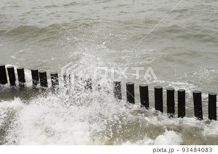 Breakwaters in the sea. Waves beat against breakwaters. Breakwaters in the sea. Waves beat against breakwaters. 93484083
