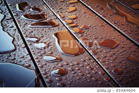 water drops on brown wooden boards 93484604
