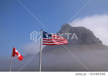 American and Canadian flags at Logan Pass 93486366