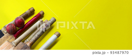 Brown wooden cricket handles which are bound by cotton yarn and artificial leather on yellow background Brown wooden cricket handles which are bound by cotton yarn and artificial leather on yellow background 93487970