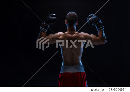 Back view of man boxer with raised hands in victory gesture. Concept of hard sport, glory and success. Back view of man boxer with raised hands in victory gesture. Concept of hard sport, glory and success. 93490844