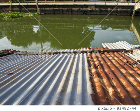 Old tin roof beside drainage canals Old tin roof beside drainage canals 93492744