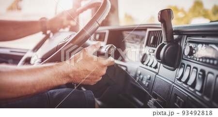 Driver of semi-truck sitting and drining his vehicle Driver of semi-truck sitting and drining his vehicle 93492818