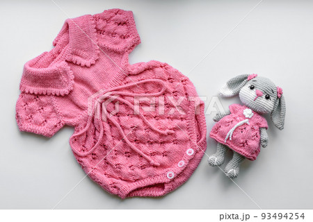Beautiful baby knitted clothes and a toy for a newborn baby 93494254