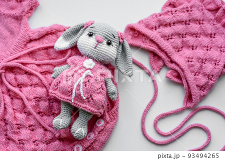 Beautiful baby knitted clothes and a toy for a newborn baby 93494265