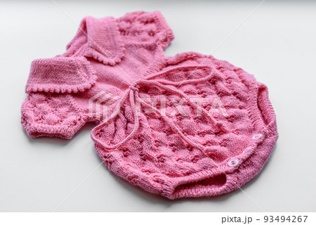 Beautiful baby knitted clothes and a toy for a newborn baby Beautiful baby knitted clothes and a toy for a newborn baby 93494267