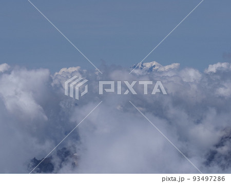 Foggy Mont Blanc peak above clouds seen from Switzerland Foggy Mont Blanc peak above clouds seen from Switzerland 93497286
