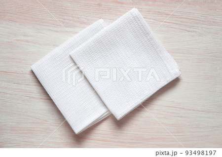 White kitchen waffle towel on wooden background. Mock up for design White kitchen waffle towel on wooden background. Mock up for design 93498197