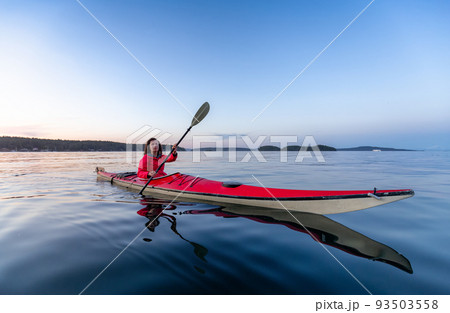 Adventurous Woman on Sea Kayak paddling in the Pacific Ocean Adventurous Woman on Sea Kayak paddling in the Pacific Ocean 93503558