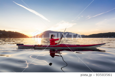 Adventurous Woman on Sea Kayak paddling in the Pacific Ocean. 93503561