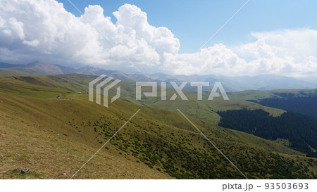 Big white clouds over green hills and mountains 93503693