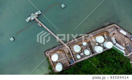 Aerial view from drone of terminal storage tank, Iindustrial facility for storage of oil and petrochemical. Business commercial trade fuel energy transport by tanker ship vessel. Aerial view from drone of terminal storage tank, Iindustrial facility for storage of oil and petrochemical. Business commercial trade fuel energy transport by tanker ship vessel. 93504414