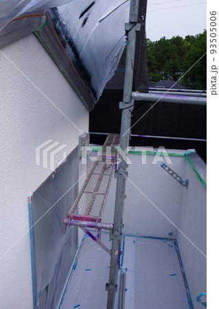 戸建て住宅の外壁塗装　屋根塗装　現場　足場の組まれた家　塗装工事　足場　住宅工事の様子　養生 93505006