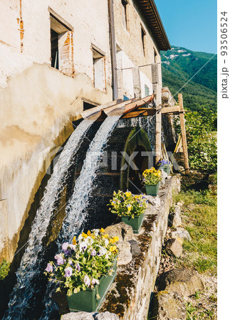 Old working watermill wheel with falling water 93506524