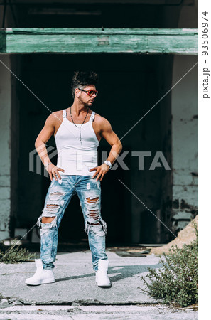 Portrait of handsome man in casual clothing posing in abandoned place, looking away to a side. Color Toned Image. Concept urban man. 93506974
