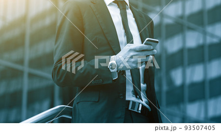 Success business man using cell phone. Blue Toned Image. Success business man using cell phone. Blue Toned Image. 93507405