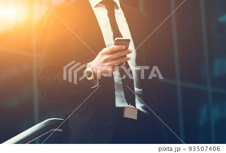 Success business man using cell phone. Concept businessman lifestyle. Toned Image. Success business man using cell phone. Concept businessman lifestyle. Toned Image. 93507406