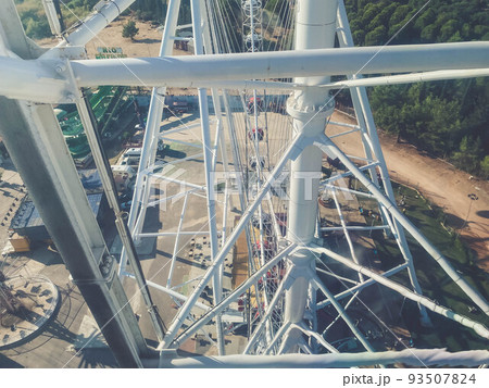 Ferris wheel. a robust, metal, white construction for lifting people and booths into the air to survey the city. amusement park 93507824