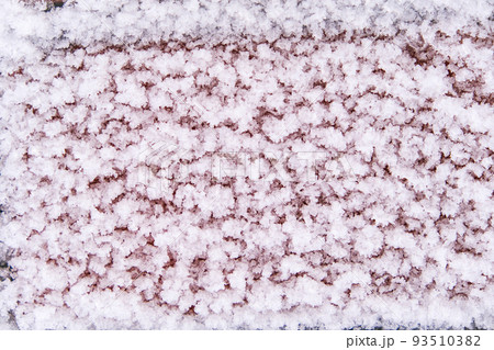 The brick wall is covered with snow patterns 93510382