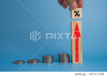 Business finance investments economy stack coin inflation and arrow red with wood cube on desk. 93517599