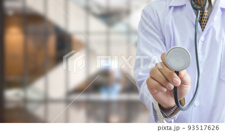 doctor uniform holding a stethoscope in hospital background copy space.Business health care concept. 93517626