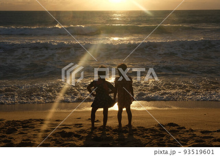 Cute Asian sisters playing on the beach during summer vacation at sunset together. Summer family trip to the beach. travel and vacation concept. 93519601