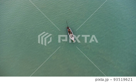Aerial view from a drone of Thai traditional longtail fishing boats sailing in the sea. Top view of a fishing boat in the ocean. 93519621