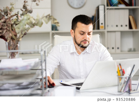 Man office worker using laptop during workday 93520886