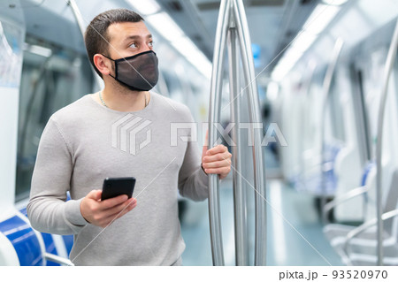 Man in protective medical masks in subway carriage Man in protective medical masks in subway carriage 93520970