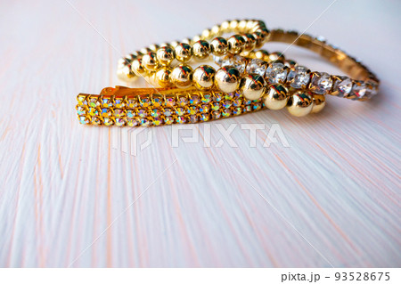 a lot of gold costume jewelry with different materials on a white background. Copy space a lot of gold costume jewelry with different materials on a white background. Copy space 93528675