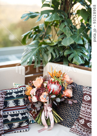 Beautiful wedding bouquet and pillows on the sofa 93528968