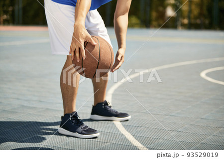 young asian male basketball player dribbling and practicing ball handling skill on court young asian male basketball player dribbling and practicing ball handling skill on court 93529019