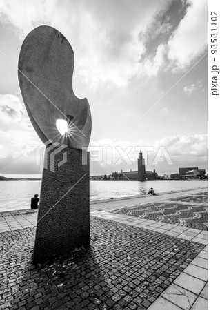 People relaxing on embankment in Stockholm 93531102