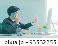Business man showing ok thumb up gesture while talking on mobile phone in the office. 93532255
