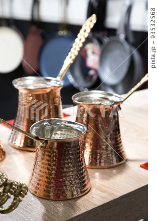 Copper Turkish coffee makers for brewing a hot drink. New crockery and utensils for the kitchen, cezve 93532568