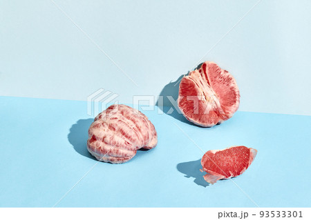Composition of fresh fruits, juicy grapefruit cutted into slices on two-color background Composition of fresh fruits, juicy grapefruit cutted into slices on two-color background 93533301