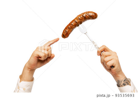 Male hands with grilled sausage on fork isolated over white studio background. German and Bavarian holidays 93535693