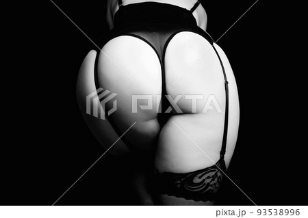 Female hips with black sexy garter belt, fishnet stockings and black panties. Close up view, isolated on black. Concept femme fatale Female hips with black sexy garter belt, fishnet stockings and black panties. Close up view, isolated on black. Concept femme fatale 93538996