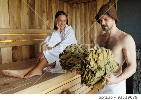 Cheerful couple relaxing in sauna during spa treatments 93539079