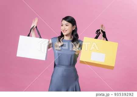 Beautiful young woman with shopping bags on color background Beautiful young woman with shopping bags on color background 93539292