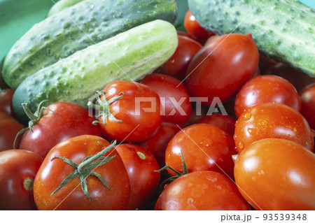 red tomatoes and cucumbers lie on the table close-up 93539348