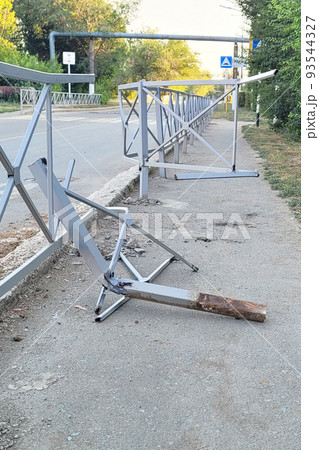 Broken road barrier as a result of a car accident 93544327