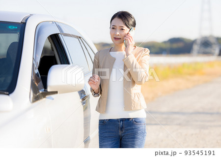 車が故障して電話をかけるミドル女性 93545191